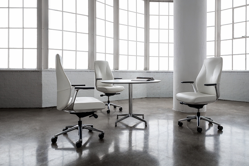Unity 6961 mid back executive conference chairs around the Juxta 47243 round conference height table in a meeting space