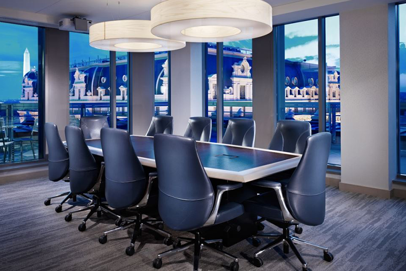 Unity 6962 mid back executive conference chairs around a conference table in a boardroom