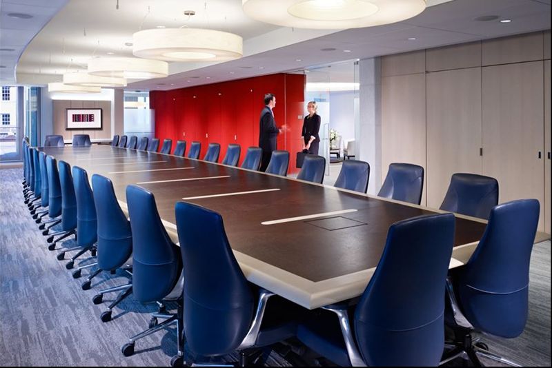 Unity 6962 mid back executive conference chair around a large conference table in a boardroom