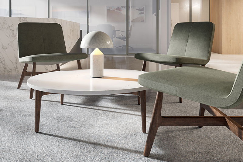 Swav armless lounge chairs around the Symm round occasional table