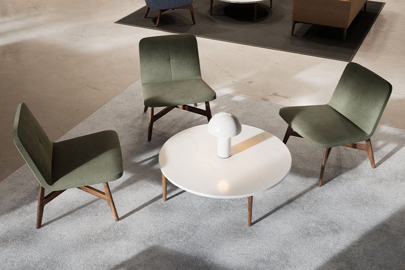 Swav armless lounge chairs around the Symm round occasional table