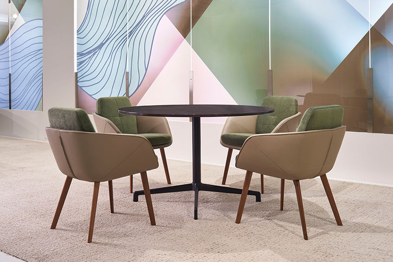 Four Symm side chairs around a Juxta LE round conference table